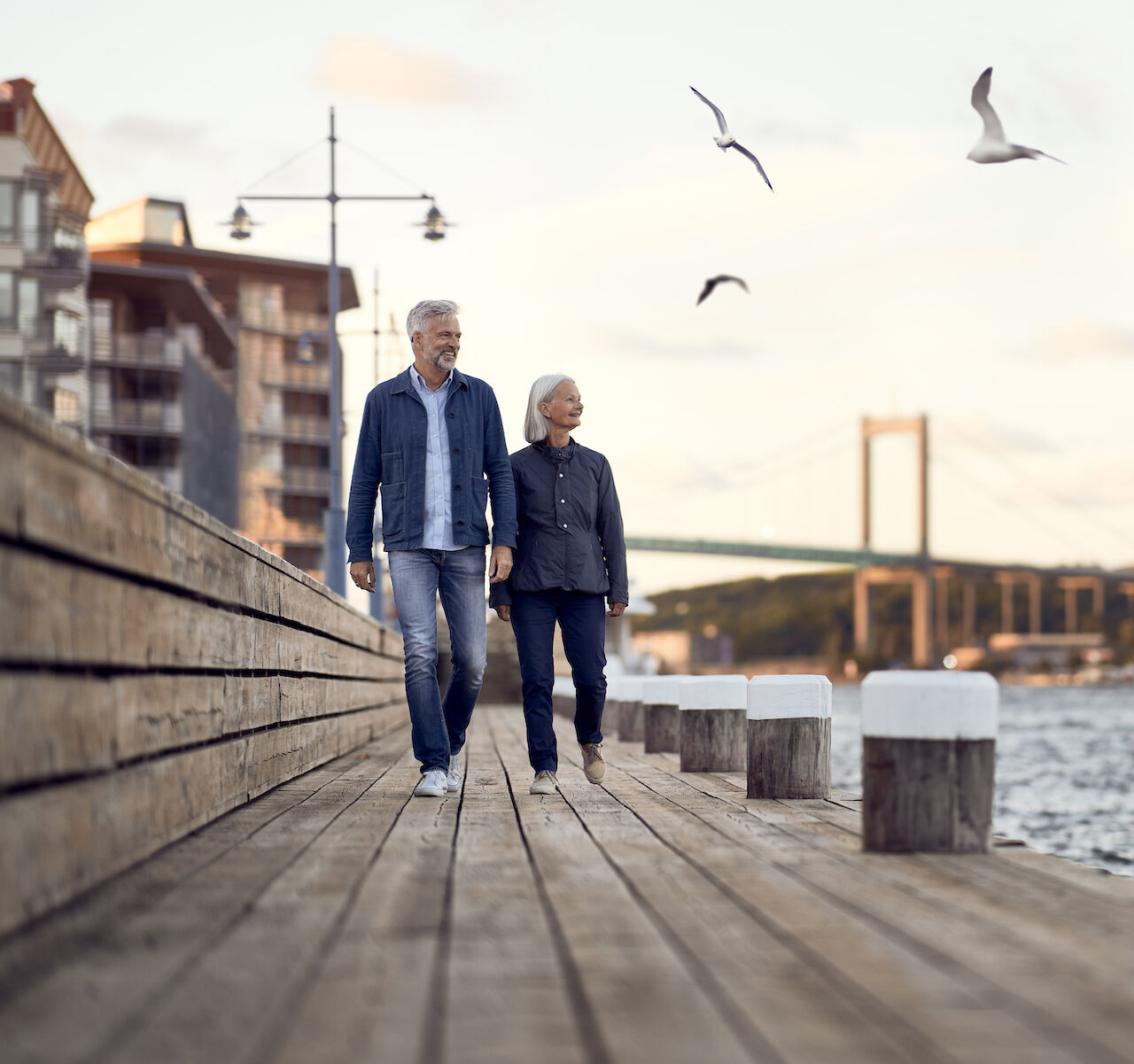 Man and woman walking along pier
